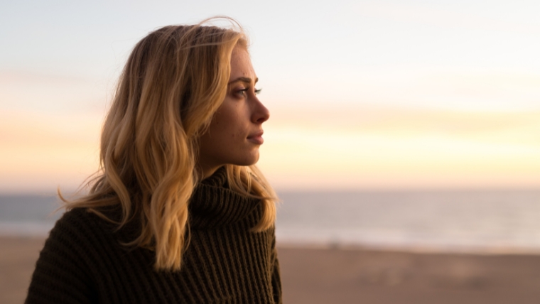 How-to-Overcome-Depression-4-Actionable-Steps Woman on beach looking off into the distance with a neutral expression | How to Overcome Depression 4 Actionable Steps | Mindful Health Solutions
