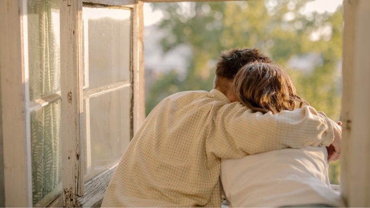 Is-Your-Relationship-Healthy-or-Codependent-How-to-Know-for-Sure A couple leaning out a window with their arms around each other | Is Your Relationship Healthy or Codependent? How to Know for Sure | Mindful Health Solutions