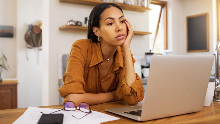 Is-Your-Perfectionism-Helping-or-Hurting-You-Healthy-vs.-Harmful-Traits Woman feeling overwhelmed and anxious about work while staring at her laptop | Is Your Perfectionism Helping or Hurting You Healthy vs. Harmful Traits | Mindful Health Solutions