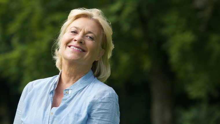 What Comes After TMS Treatment Embrace Pain-Free Living A woman smiling while standing outside | What Comes After TMS Treatment Embrace Pain-Free Living | Mindful Health Solutions