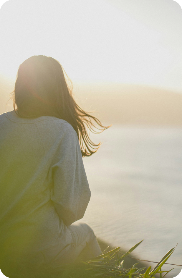 Woman sitting on a lakeside; fast TMS for depression